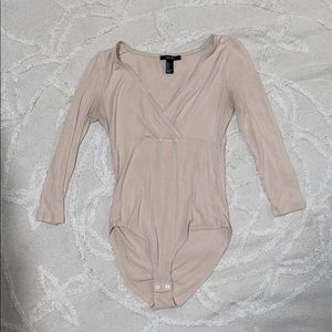Cream low neck body suit.